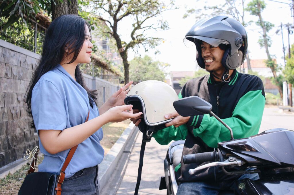 Gojek Giving Helmet to Passenger